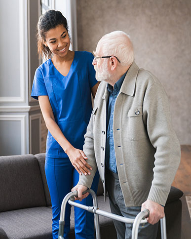 portrait of an african young nurse helping old elderly disable man grandfather to walk using walker equipment in the bedroom. senior patient of nursing home moving with walking frame and nurse support